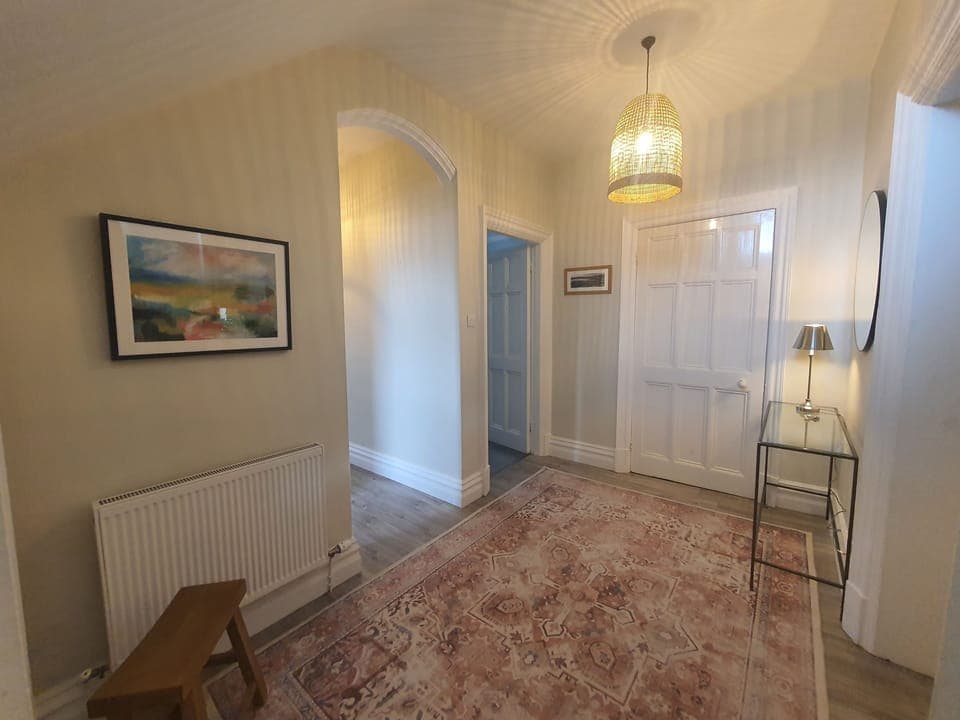 The front door opens into a spacious and elegant hallway