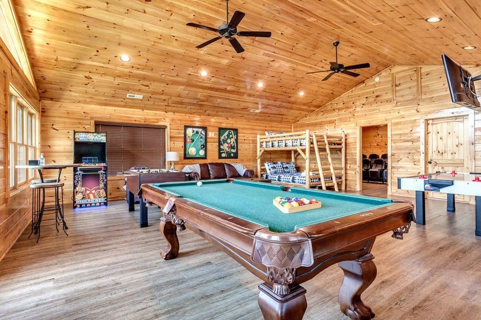 The game room is equipped with a TV, a Multicade video game machine, a pool table, an air hockey table, a foosball table, card and board games!
