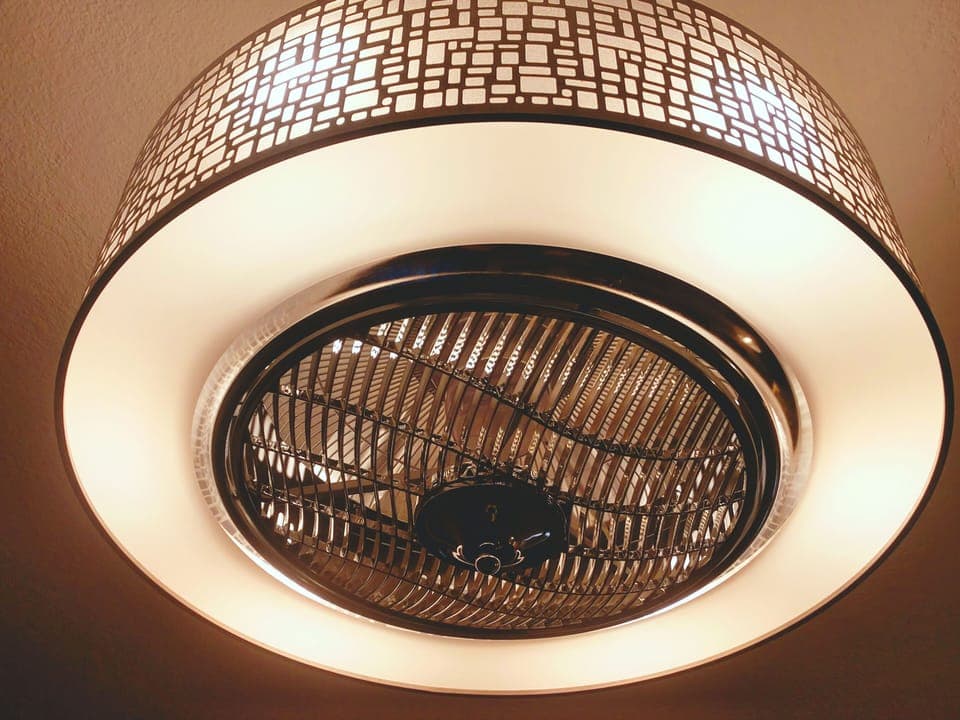 Luxurious motion ceiling fan above living room, blades are inside 
