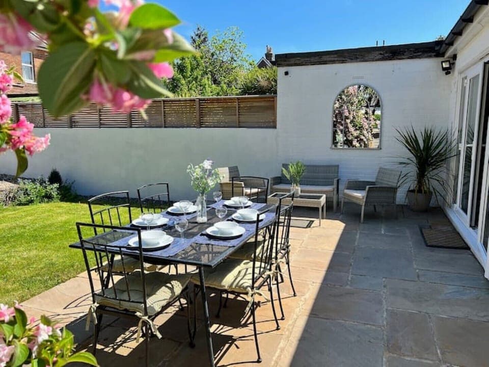 Garden with outdoor dining table and sofas