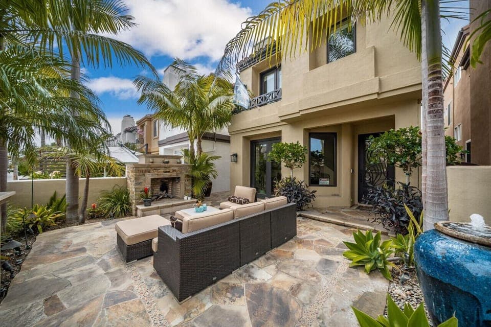 outdoor seating area with fireplace and water fountain.