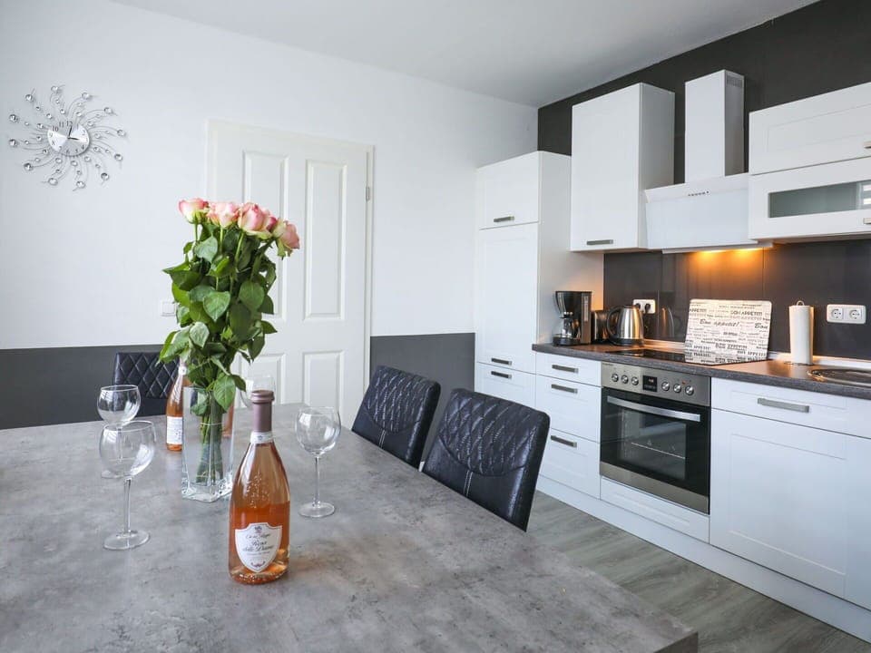 Furniture, Cabinetry, Property, Flower, Countertop, Bottle, Interior Design, Orange, Plant, Kitchen Stove