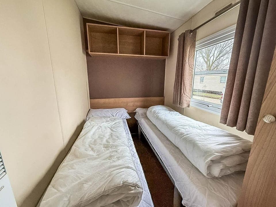 Cozy twin bedroom with natural light and storage space