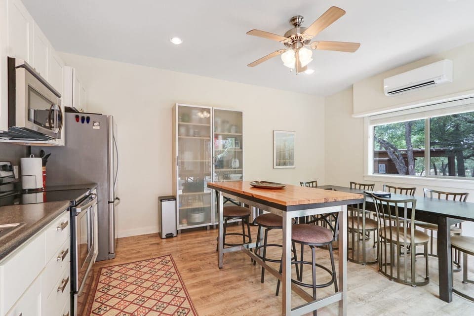 View of the communal kitchen showing range, oven, microwave, and dishwasher.
