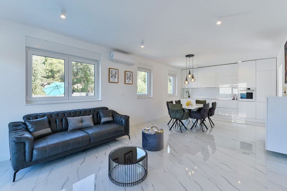 Gorgeous open-concept living area with exit to the balcony