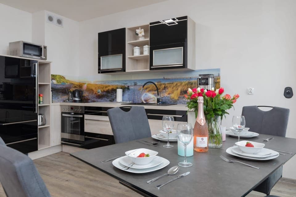A dining area adjacent to the kitchen, with a table set for a delightful meal.
