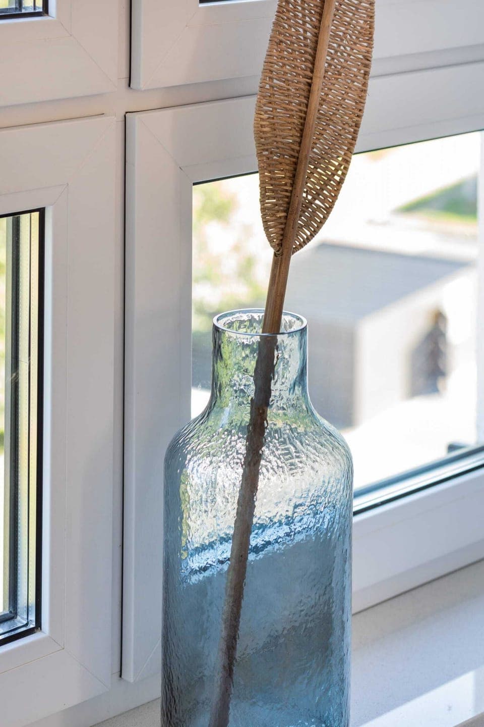 A close-up of decorative details, such as woven elements near the window, enhancing the natural vibe.
