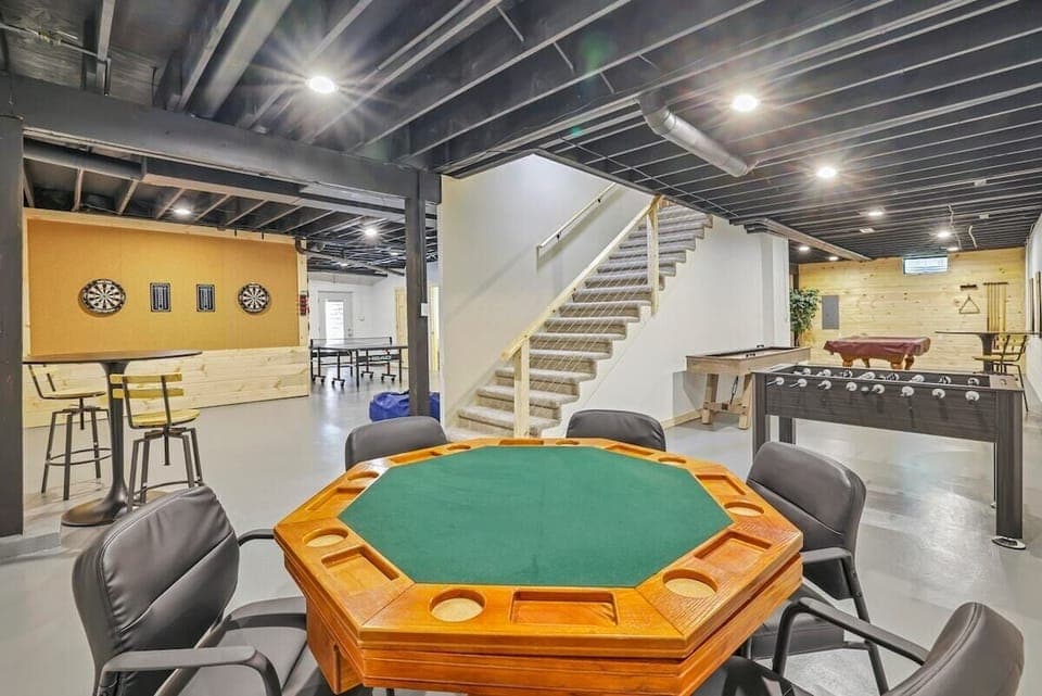 Poker table, foosball table, shuffle board table, and dart boards located in the walk-out basement