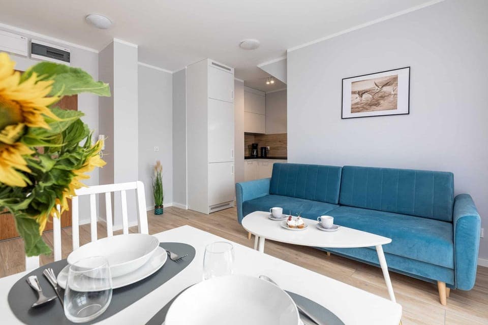 The elegant living room featuring a double sofa bed.