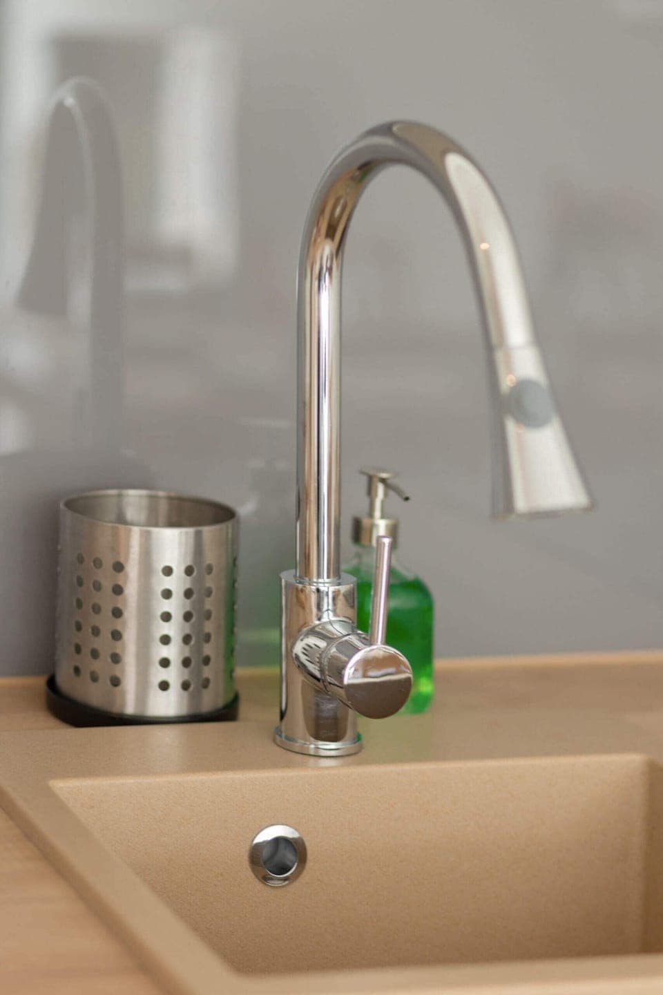 A close-up of the kitchen sink with a modern faucet, showing attention to detail in the kitchen’s design and functionality.