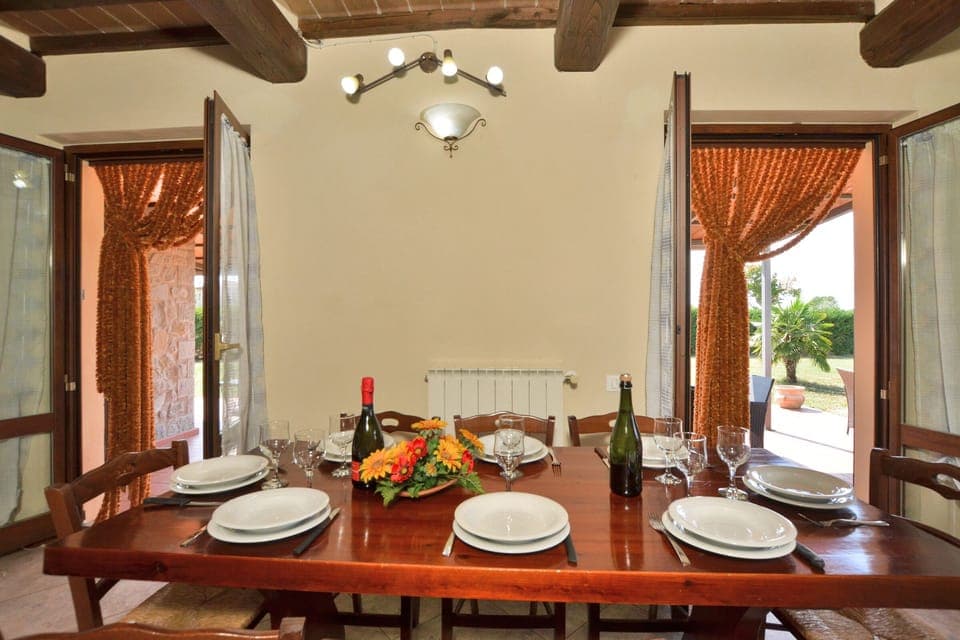 The dining area in the kitchen open to the equipped pergola