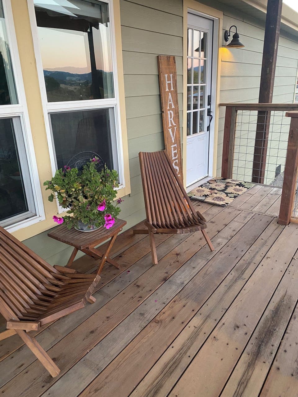 Front deck with two chairs and a bench that coverts to a picnic table, seats 6