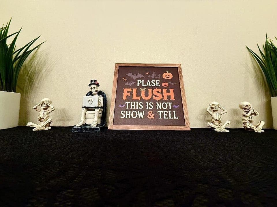 Skeleton Sign Detail
Cheeky skeletons and a playful sign bring humor and Halloween spirit into the bathroom.

