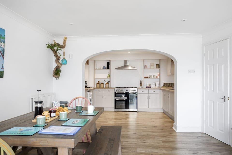 Open modern fitted kitchen leading to dining area