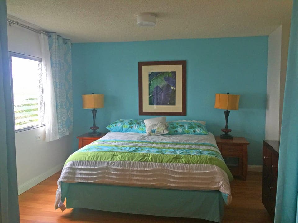 Bedroom alcove separated from living room by privacy curtain
