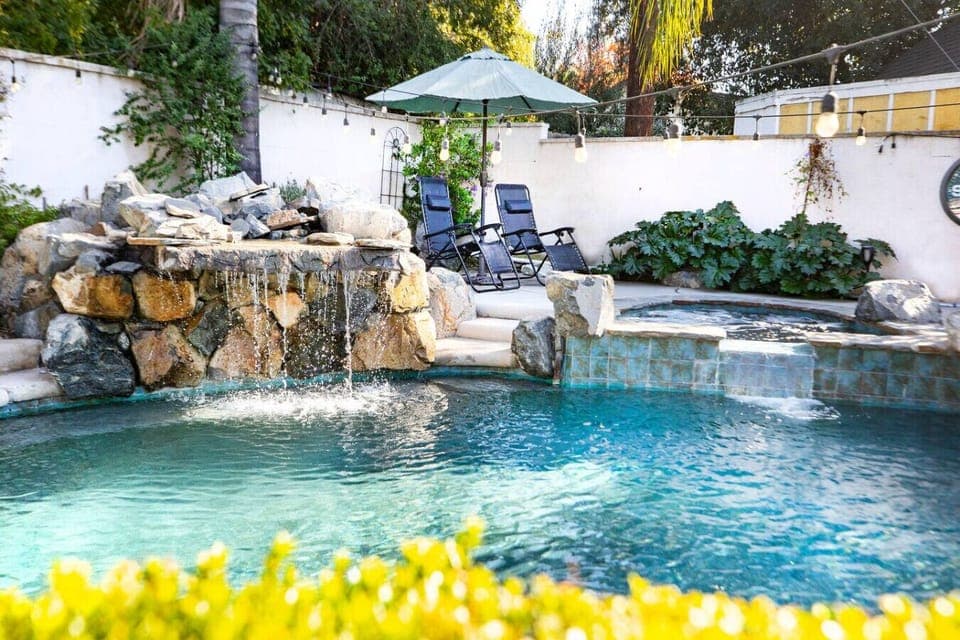 Lounge in privacy surrounded by beautiful purple sky flowers, our wonderful spa and the meditative sound of our natural stone waterfall.