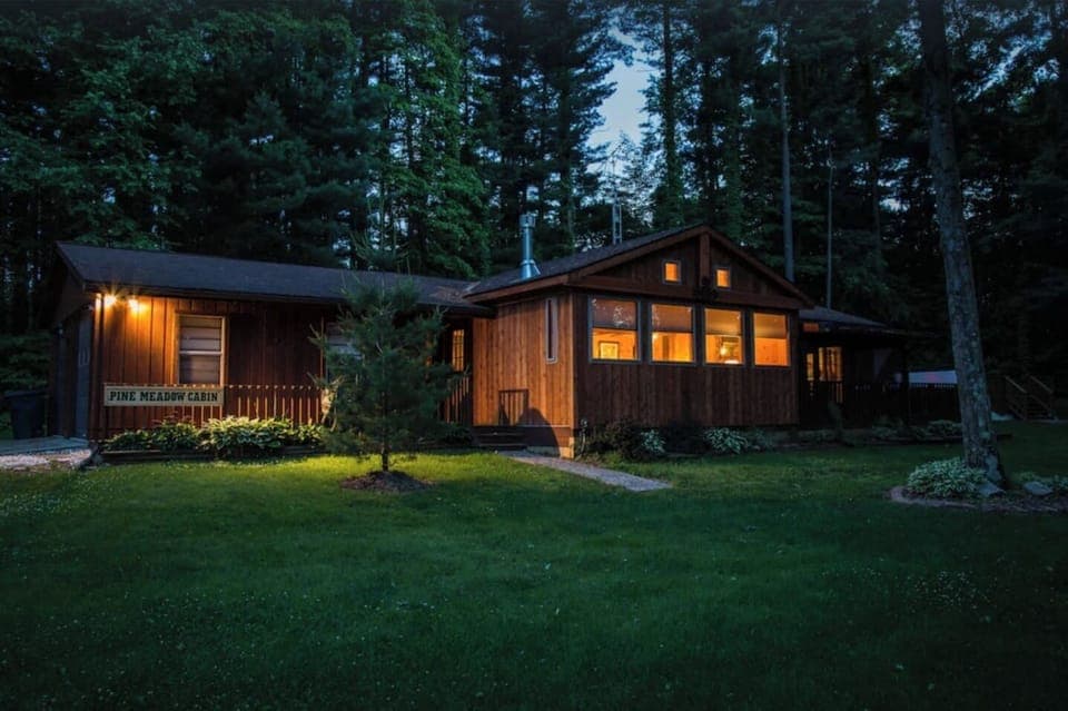 Serene view of Pine Meadow Cabin at night. 
