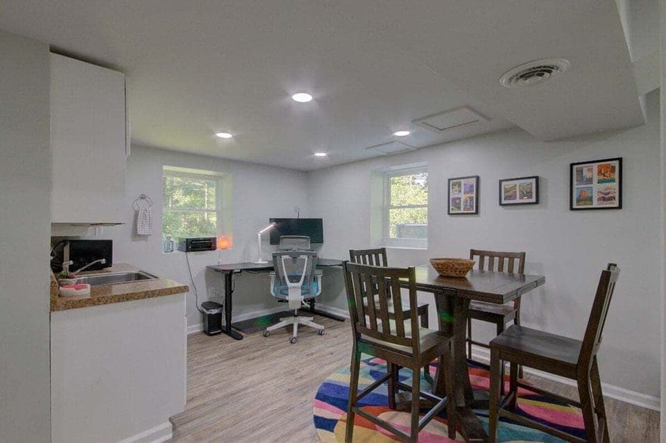 Seating area in lower level with kitchenette and office nook.