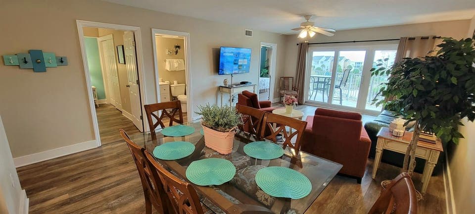 Living space with 55" Roku 4K smart tv and dining area with seating for six