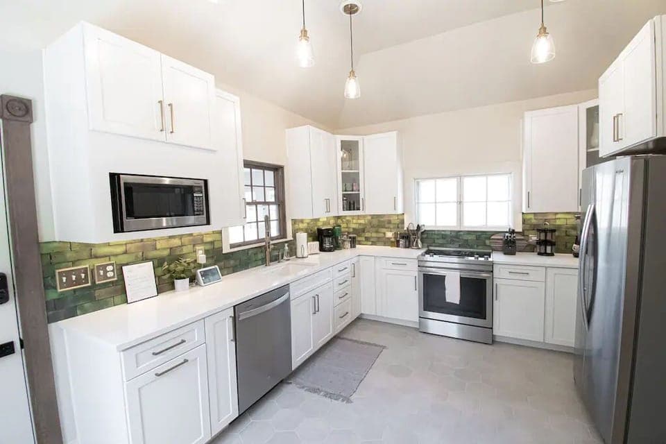 A beautifully renovated kitchen featuring brand-new appliances and a crisp green tile backsplash—fresh, inviting, and full of personality. 🍃✨