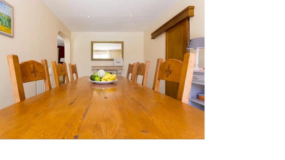 dining room, table seats 8, antique dresser and mirrors