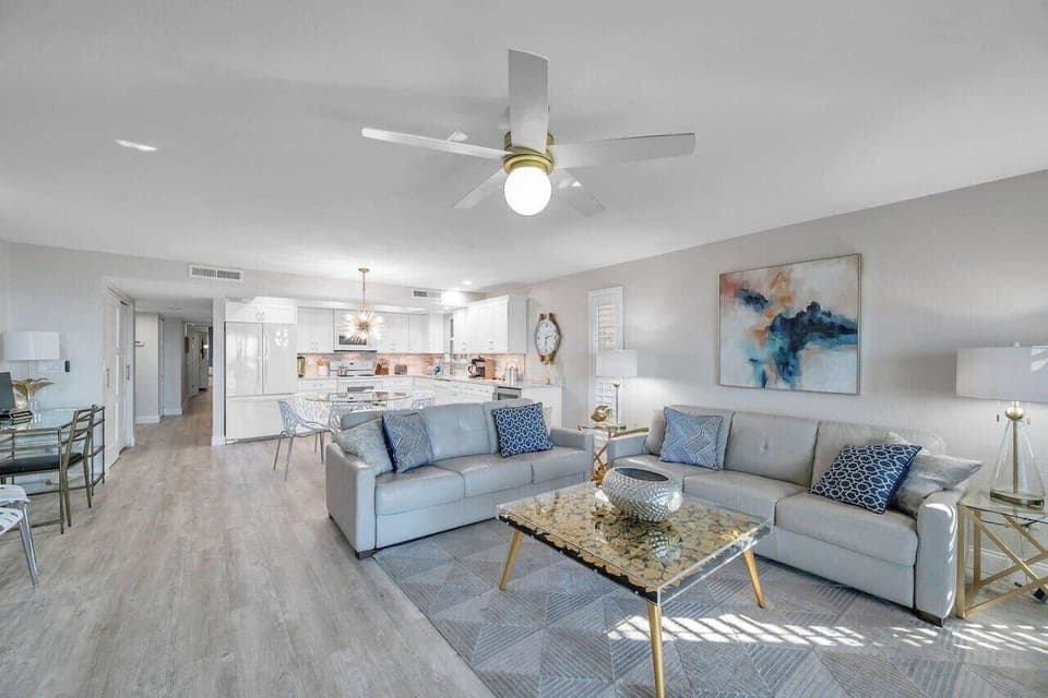 Open living room w/ plush seating and bright coastal style, designed for easy lounging and conversation.