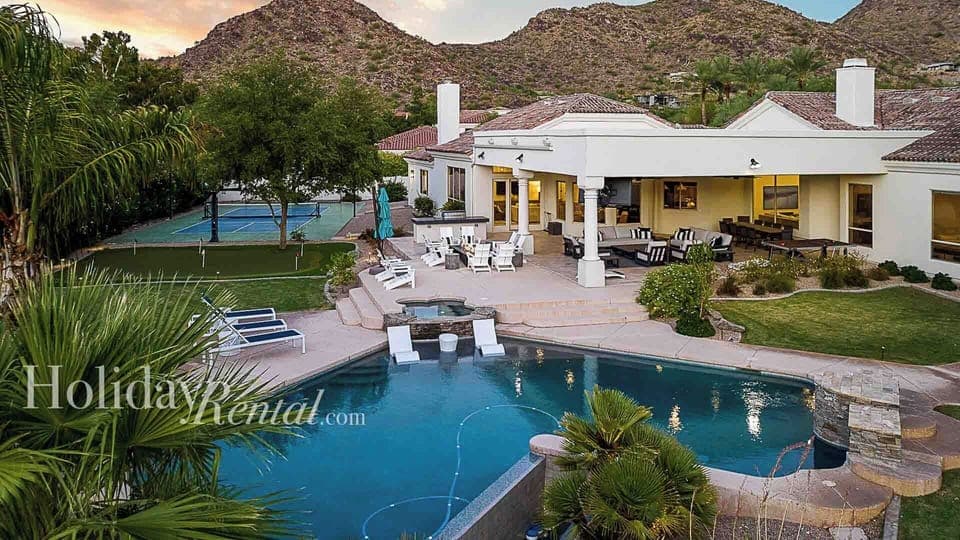 Large entertainment backyard w/ loungers, pool, spa, firepit, and games.