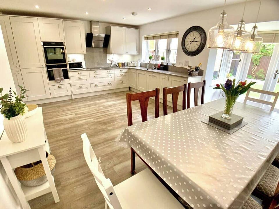 Large kitchen diner with table to seat 8 (plus high chair if required, x2 available on request). Patio doors open onto a pretty sunny garden leading to the Summerhouse.