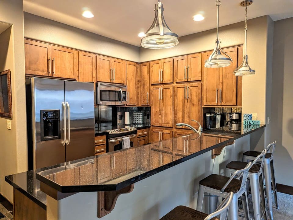 Fully stocked kitchen with electric stove, microwave, and dishwasher