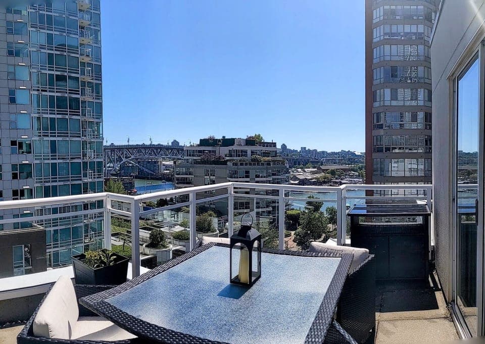 Main large deck off the living area with outdoor dining set with water views.