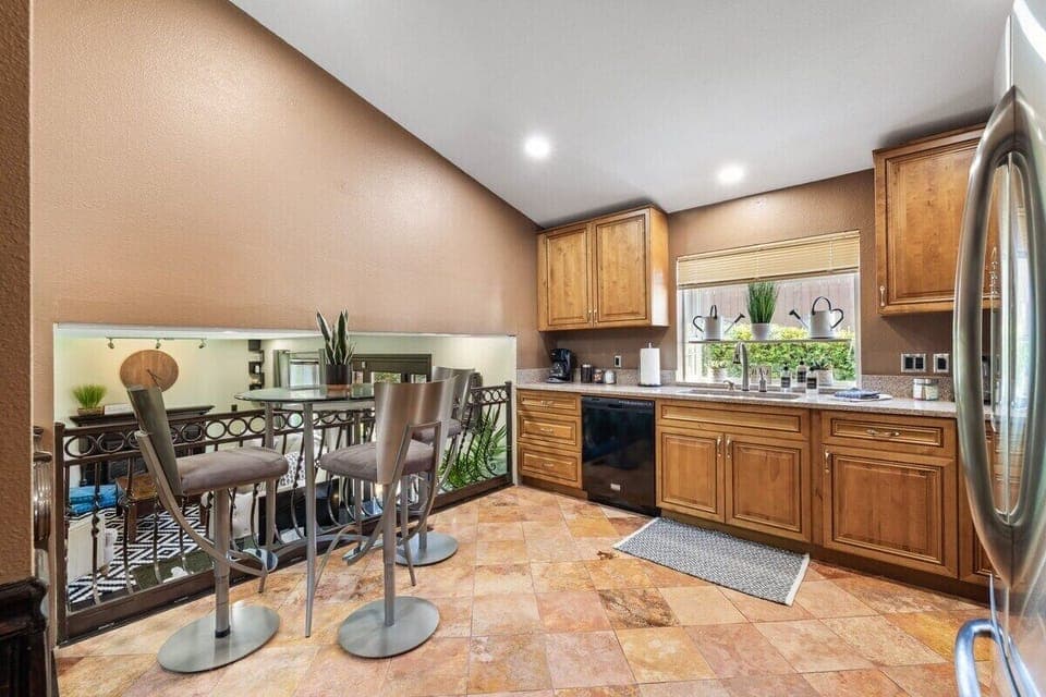 Discover the heart of the home in this well-equipped kitchen featuring a charming coffee nook, perfect for your morning brew. The kitchen offers a spacious layout and modern appliances for preparing delicious meals. 