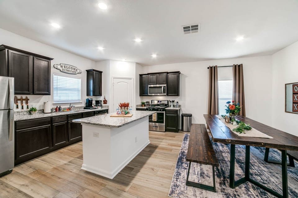 Spacious kitchen with gas stove and a large, handmade farmhouse table!