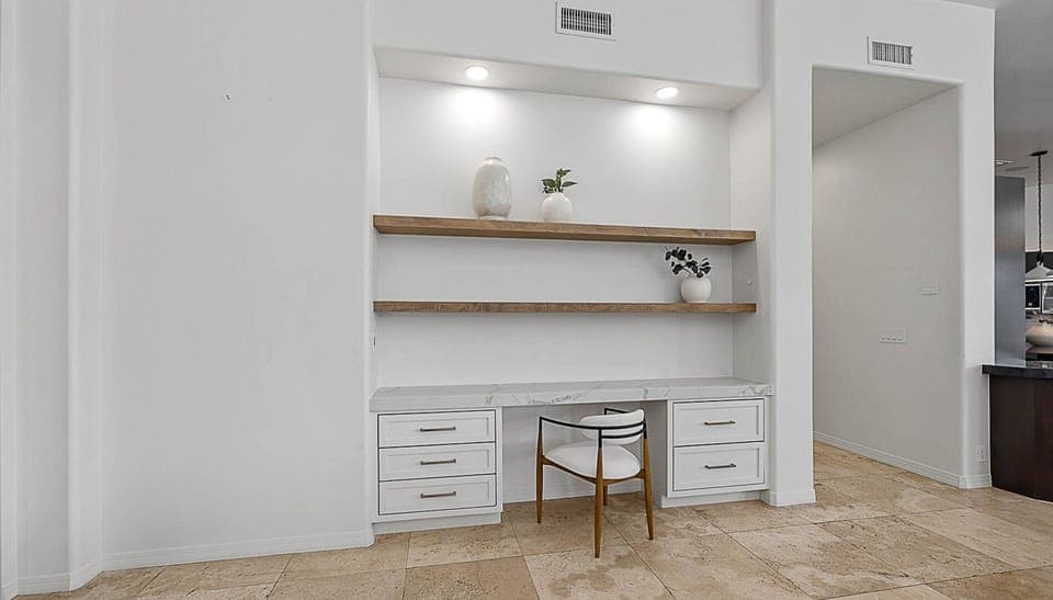 Work desk w/ shelves located near the kitchen & main living room
