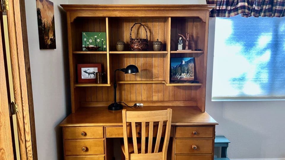Primary bedroom has working desk, perfect for remote work or catching up on emails
