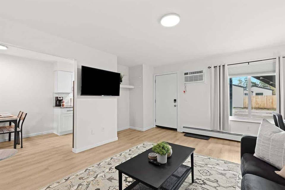 Enjoy a bright, modern space with smart TV, stylish seating, and plenty of natural light.