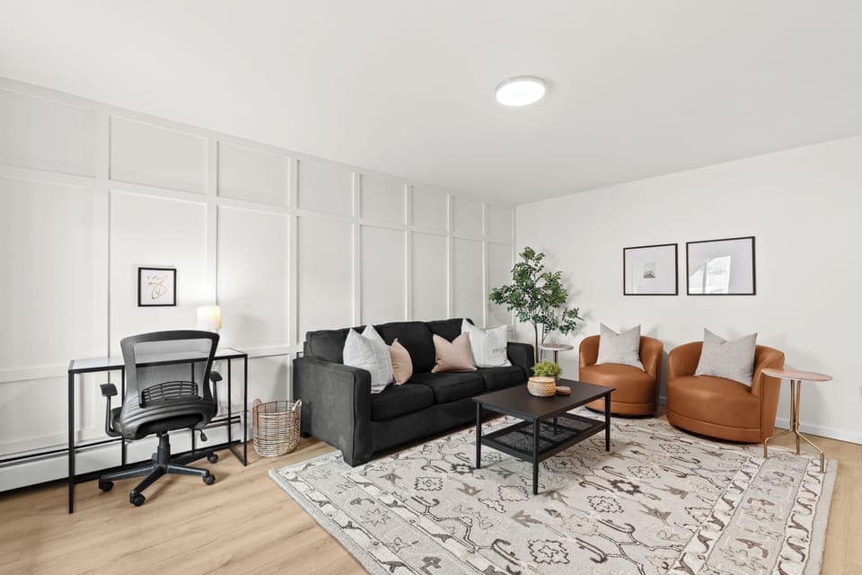 Bright, modern living room with work-from-home desk and plenty of cozy seating.