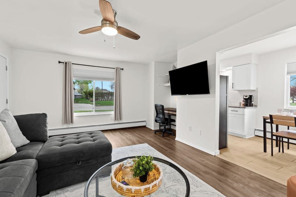 Comfy living space with work desk and mounted Smart TV
