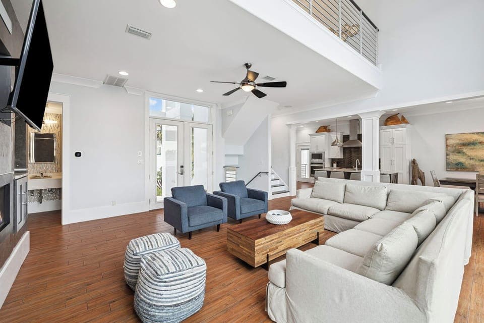 Unwind in your spacious living room where soaring ceilings and plush seating create the perfect gathering space for memorable evenings together.