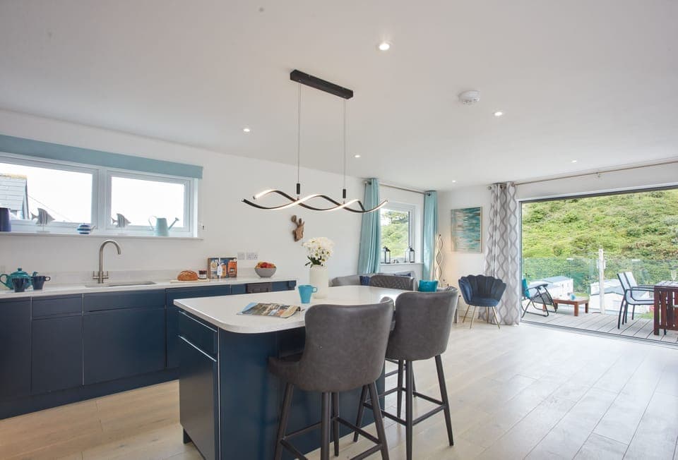 Anneth Lowen, Polzeath. Well equipped kitchen area with contemporary units, American Fridge/freezer, electric oven and ceramic hob, microwave and dishwasher