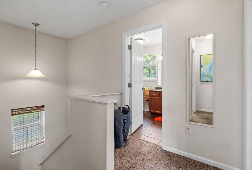 Bright & Breezy – Natural light and a neutral palette make this shared bath feel airy and open.