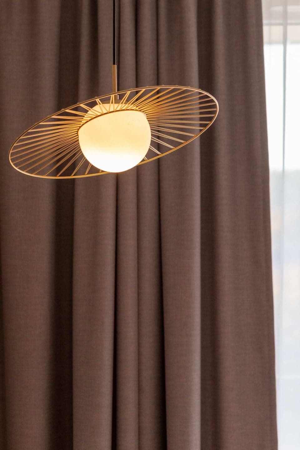 A stylish ceiling light with a warm, modern design, complementing the room's aesthetic.
