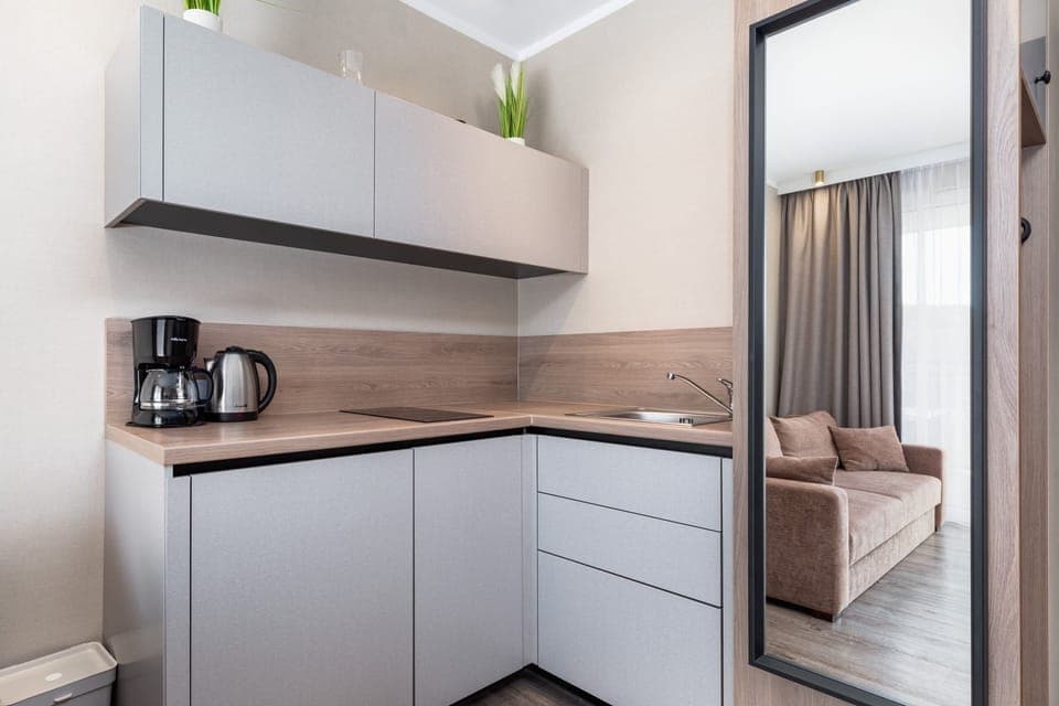 A sleek and fully equipped kitchen with modern appliances and minimalist design.
