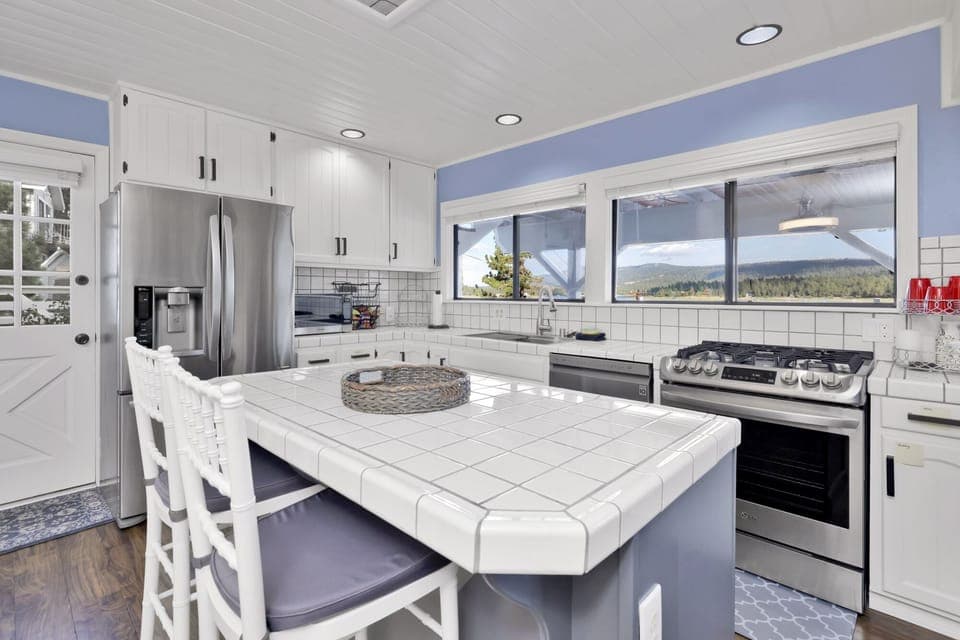 Fully equipped cabin kitchen with ample cabinetry, stove, fridge, microwave, and coffee maker—perfect for cooking meals, morning coffee, and feeling right at home on your stay.