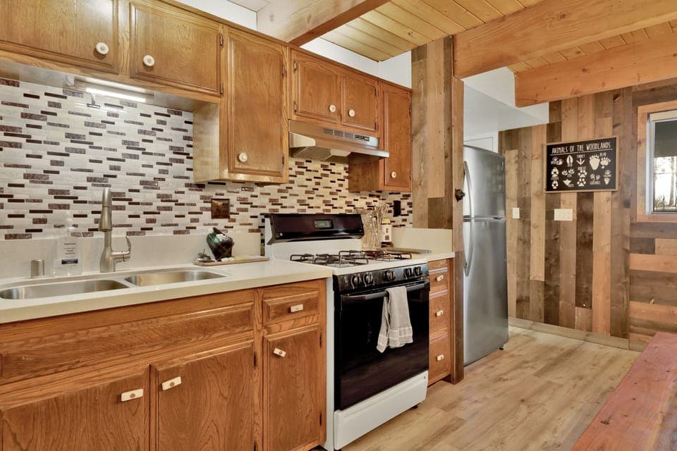 Fully equipped cabin kitchen with ample cabinetry, stove, fridge, microwave, and coffee maker—perfect for cooking meals, morning coffee, and feeling right at home on your stay.