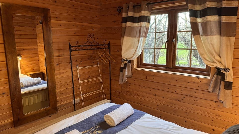 Double bedroom with hanging rail and rural views