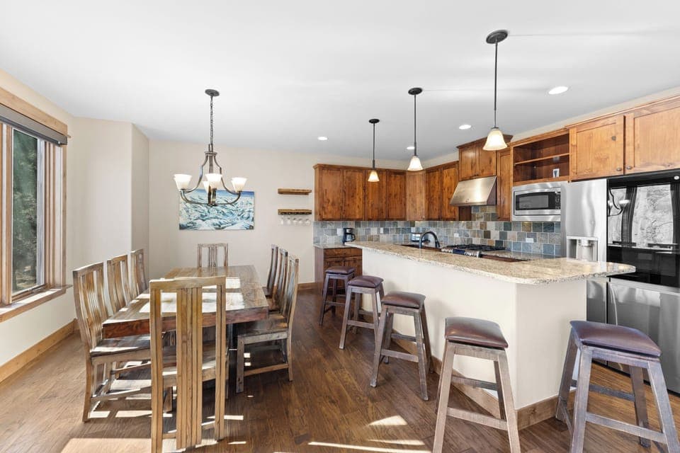 Full size kitchen with granite countertops, high end stainless steel appliances, and breakfast bar for additional seating