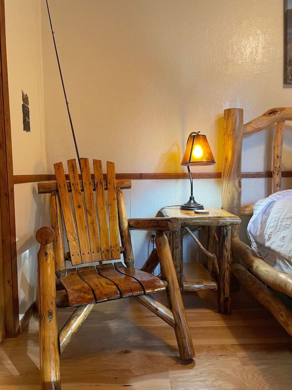 Wooden chair and side table with a warm glowing lamp
