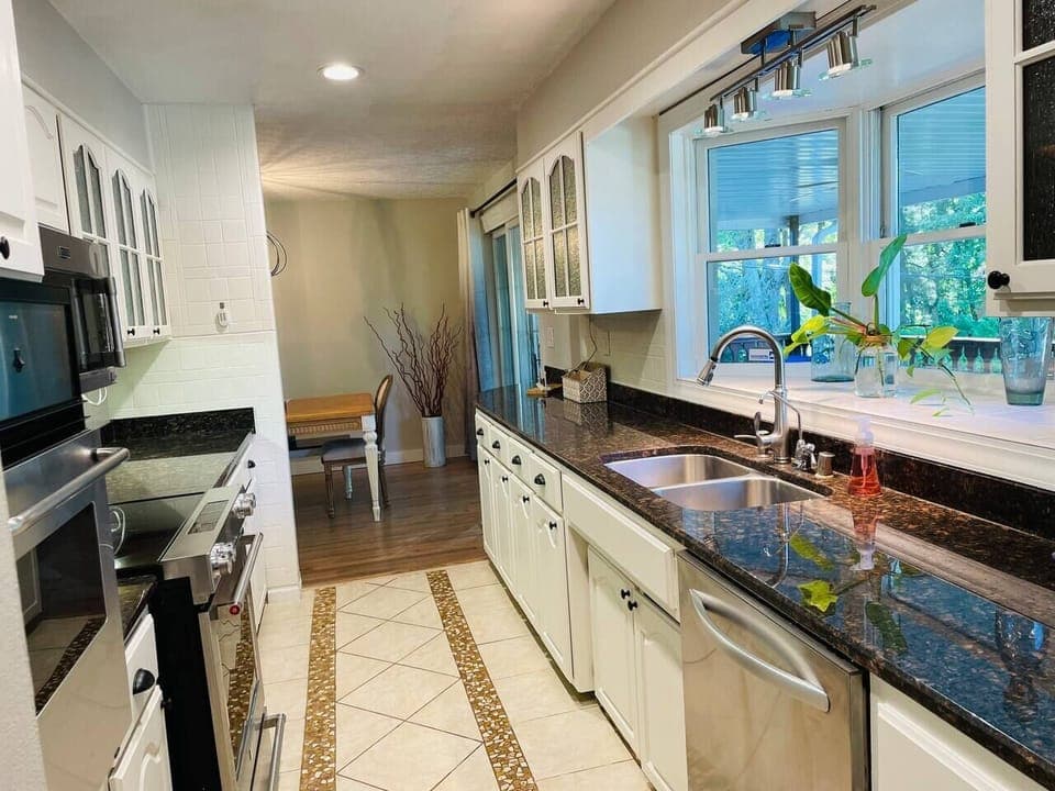 The kitchen includes two ovens, dishwasher, stainless steel fridge, crockpot, keurig, drip coffee maker, electric griddle, toaster, and more!