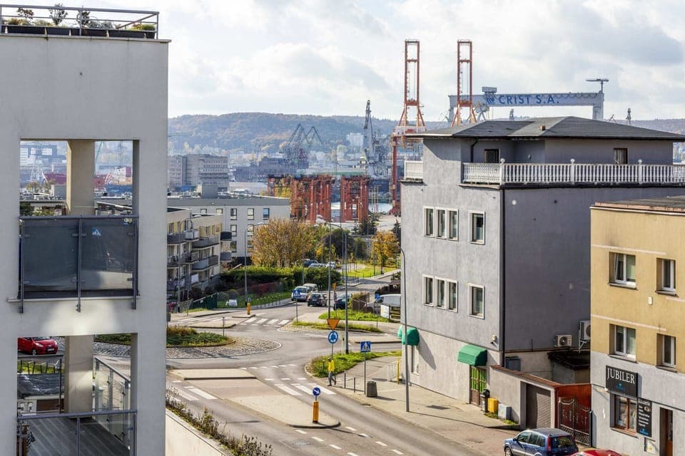 View of a vibrant urban district with views of rooftops, streets or industrial buildings.