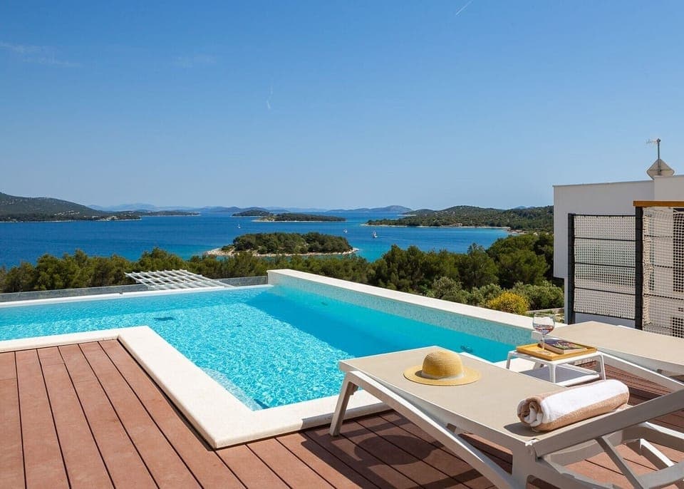 View of the sea and the islands from the terrace of the Luxury Villa Murter Exotic on Murter with heated pool and sun loungers